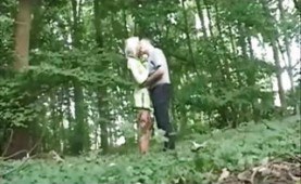 Blonde girl fucks an old guy in the forest