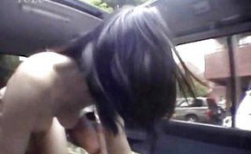 Asian couple having sex in a moving car