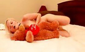 Cute teen playing with her teddy bear