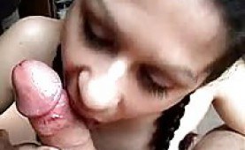 Pigtailed amateur giving an upclose blowjob