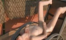 Sexy girl fingering her snatch on a sun bed