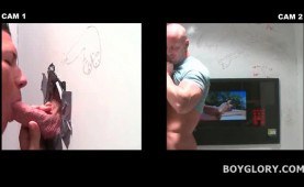 Muscled stud enjoys gay gloryhole oral sex