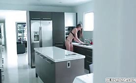 Stepson gets an eyeful as stepmom stands at the kitchen sink