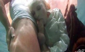 Dressed blonde giving head under water