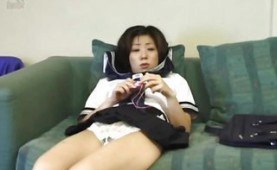 Asian teen toying on the sofa